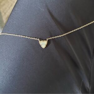 Kendra Scott necklace. Rose gold band and off-white sparkly charm.